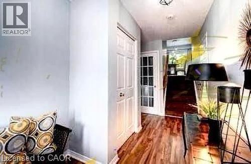 Hallway featuring wood-finish flooring, white paneled doors, and a glass-paned door - 175 David Bergey Drive Unit# L74, Kitchener, ON -  Photo Showing Other Room