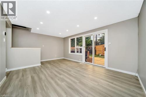 Spacious room featuring light-toned wood-finish flooring, recessed ceiling lighting, and a neutral wall color - 53 Burns Drive, Guelph, ON - Indoor Photo Showing Other Room