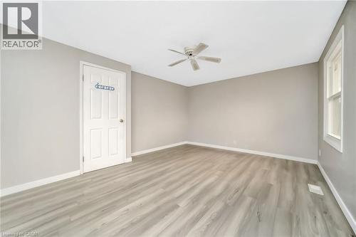 Spacious room with light gray walls, wood-finish flooring, a ceiling fan, and white trim - 53 Burns Drive, Guelph, ON - Indoor Photo Showing Other Room