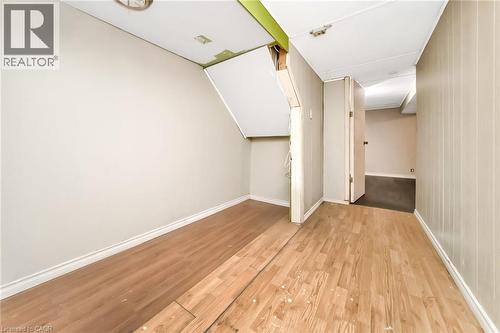 Interior room with wood-finish flooring, white baseboards, and light-toned walls - 53 Burns Drive, Guelph, ON - Indoor Photo Showing Other Room
