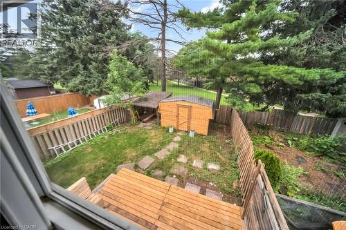 Expansive backyard featuring a multi-level wood deck, a storage shed, and mature perimeter trees - 53 Burns Drive, Guelph, ON - Outdoor With Deck Patio Veranda
