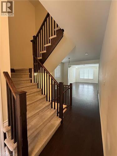 Entryway featuring a carpeted staircase with dark wood-finish railings, recessed lighting, and rich wood-finish flooring extending into the open concept living areas - 63 Ridge Road, Cambridge, ON - Indoor Photo Showing Other Room
