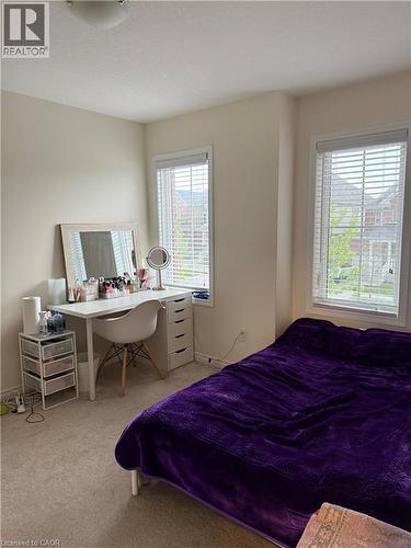 Carpeted room featuring two windows with horizontal blinds, providing ample natural light - 63 Ridge Road, Cambridge, ON - Indoor Photo Showing Bedroom