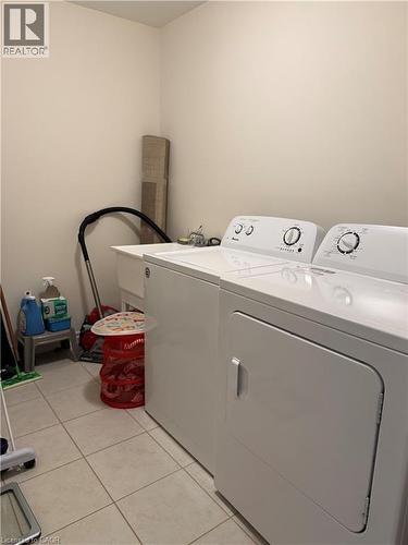 Laundry area with light-toned wall paint and light-toned tile flooring - 63 Ridge Road, Cambridge, ON - Indoor Photo Showing Laundry Room