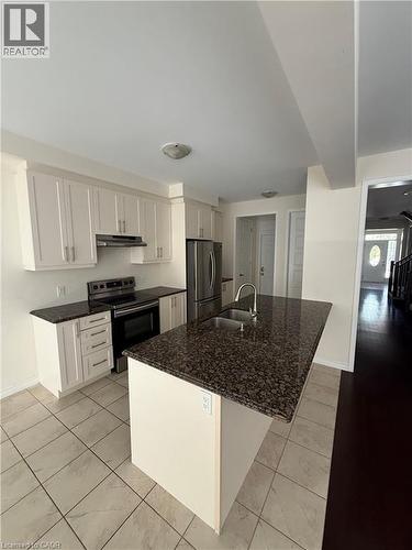 Kitchen featuring white cabinetry, stainless steel appliances, granite countertops, and a central island with an undermount sink - 63 Ridge Road, Cambridge, ON - Indoor Photo Showing Kitchen With Stainless Steel Kitchen With Double Sink