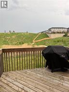 Expansive outdoor deck with natural wood flooring and coordinating wood railing - 