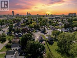 Residential neighborhood featuring a mix of housing styles, abundant mature trees, and visible street infrastructure - 