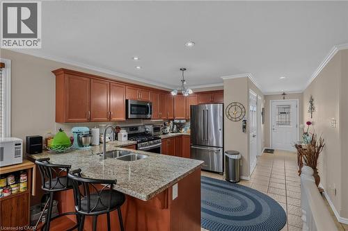 granite counter top, stools inlcuded double sink - 49 Millcroft Drive, Simcoe, ON - Indoor Photo Showing Kitchen With Double Sink