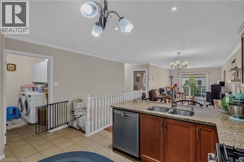Laundry off to the side of the kitchen - 49 Millcroft Drive, Simcoe, ON - Indoor Photo Showing Kitchen With Double Sink