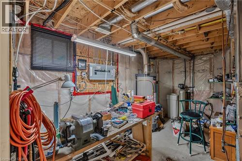 workshop furnace water softener/hot water tank tooks - 49 Millcroft Drive, Simcoe, ON - Indoor Photo Showing Basement