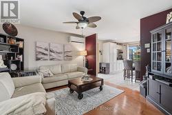 Spacious living room with wood flooring. - 
