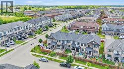 Aerial perspective showcasing a modern residential neighborhood with a variety of townhome and detached property styles - 