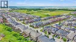 Aerial perspective showcasing a residential community with diverse housing styles, including detached homes and townhouses - 