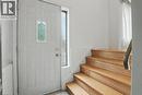Entryway featuring a paneled door with decorative glass insert and a sidelight, alongside wood-finish stairs with a coordinating handrail - 396 Pinemeadow Avenue, Mississauga, ON  - Indoor Photo Showing Other Room 