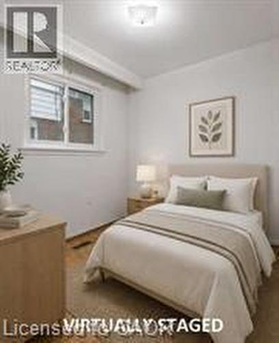 White walls, wood-finish flooring, and a flush mount ceiling light fixture - 396 Pinemeadow Avenue, Mississauga, ON - Indoor Photo Showing Bedroom