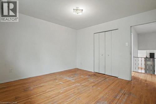 Hardwood flooring throughout, featuring a bi-fold closet and flush-mount ceiling light - 396 Pinemeadow Avenue, Mississauga, ON - Indoor Photo Showing Other Room