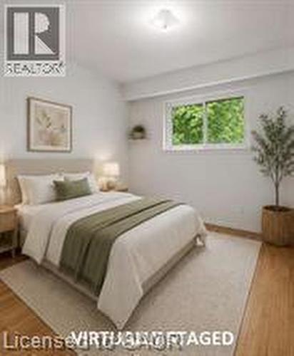 Light-filled room featuring wood-finish flooring, a flush-mount ceiling light, and a window with exterior foliage - 396 Pinemeadow Avenue, Mississauga, ON - Indoor Photo Showing Bedroom