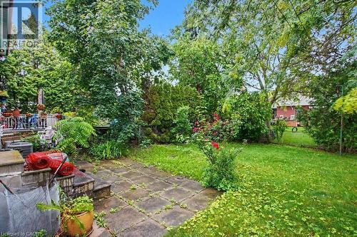 Private backyard featuring mature trees, established plantings, a paved patio, and a grass lawn - 396 Pinemeadow Avenue, Mississauga, ON - Outdoor