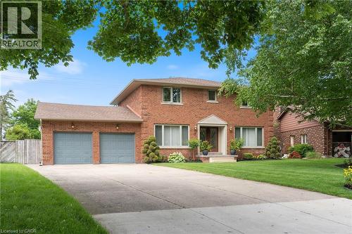 Brick two-story residence featuring a covered front entry with white trim - 7 Thomson Road, Simcoe, ON - Outdoor With Facade