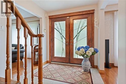 Wood double entry doors with decorative frosted glass panels - 7 Thomson Road, Simcoe, ON - Indoor Photo Showing Other Room
