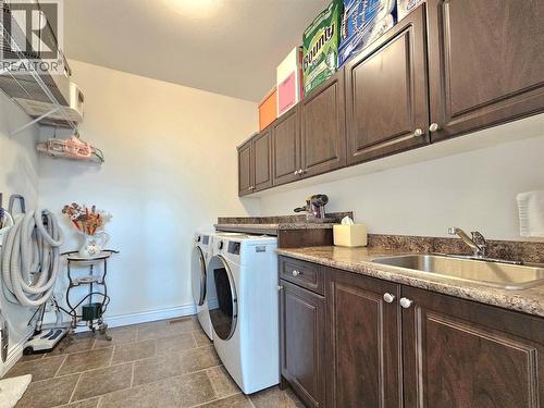Laundry on the main floor - 1494 Montenegro Drive, Kelowna, BC - Indoor Photo Showing Laundry Room