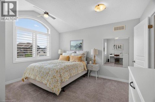 Vaulted ceiling with an arched window featuring plantation shutters - 87 Boyd Boulevard, Thamesford, ON - Indoor Photo Showing Bedroom