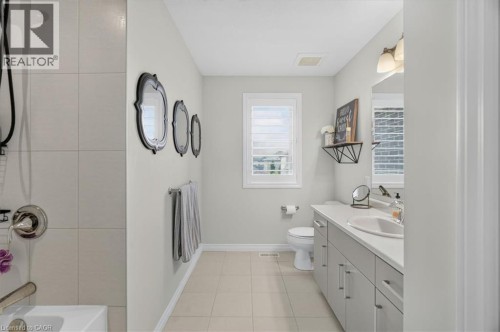 Full bathroom featuring a single vanity, integrated sink, and white countertop - 87 Boyd Boulevard, Thamesford, ON - Indoor Photo Showing Bathroom