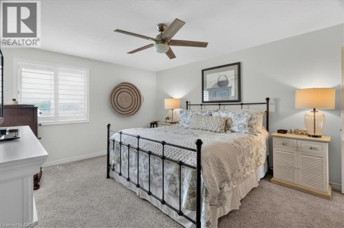 Plush carpeting throughout, paired with a ceiling fan featuring a central light fixture - 87 Boyd Boulevard, Thamesford, ON - Indoor Photo Showing Bedroom