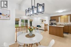 Open-concept living area with light wood-finish flooring - 