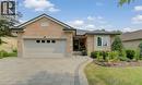 Brick facade residence featuring an attached garage with panel detailing, a paver driveway, and a curved paver walkway leading to the entrance - 249 Dearborn Boulevard, Waterloo, ON  - Outdoor 