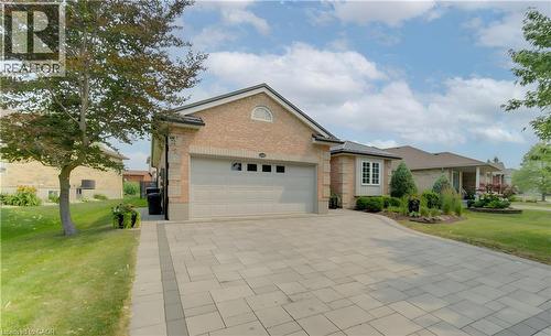 Brick exterior residence with an integrated garage, featuring a paved driveway and mature landscaping - 249 Dearborn Boulevard, Waterloo, ON - Outdoor