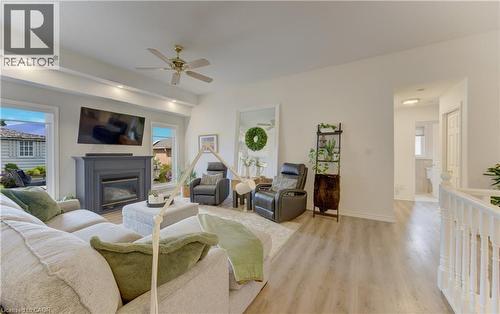 Bright living area featuring wood-finish flooring and a vaulted ceiling with a ceiling fan - 249 Dearborn Boulevard, Waterloo, ON - Indoor Photo Showing Living Room With Fireplace