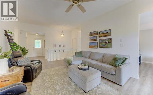 Spacious living area featuring light-toned wood-finish flooring, a ceiling fan, and white painted walls - 249 Dearborn Boulevard, Waterloo, ON - Indoor Photo Showing Living Room