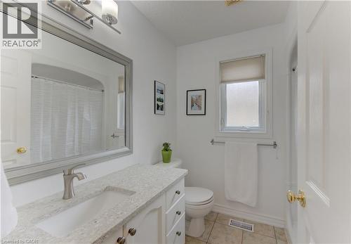 Bathroom featuring a vanity with an integrated sink, brushed nickel faucet, and a large framed mirror - 249 Dearborn Boulevard, Waterloo, ON - Indoor Photo Showing Bathroom