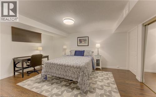Bedroom featuring wood-finish flooring, white walls, and a recessed ceiling light - 249 Dearborn Boulevard, Waterloo, ON - Indoor Photo Showing Bedroom