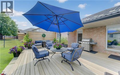 Spacious wood deck featuring an attached grill, brick exterior, and a privacy fence - 249 Dearborn Boulevard, Waterloo, ON - Outdoor With Deck Patio Veranda With Exterior