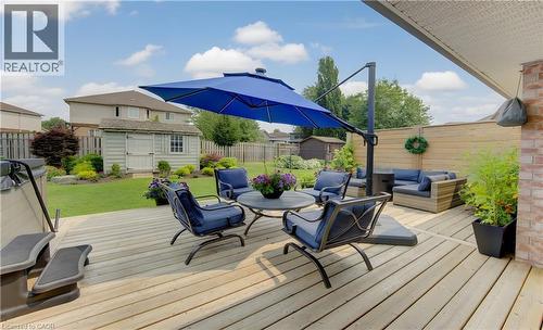 Expansive wood deck featuring a covered portion and a private wood fence - 249 Dearborn Boulevard, Waterloo, ON - Outdoor With Deck Patio Veranda With Exterior