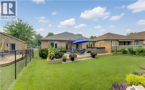 Expansive backyard featuring a large lawn, a multi-level wooden deck, and a hot tub - 249 Dearborn Boulevard, Waterloo, ON - Outdoor With Deck Patio Veranda