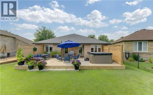 Expansive backyard featuring a multi-level wood deck, a built-in hot tub, and a surrounding privacy fence - 249 Dearborn Boulevard, Waterloo, ON - Outdoor With Deck Patio Veranda