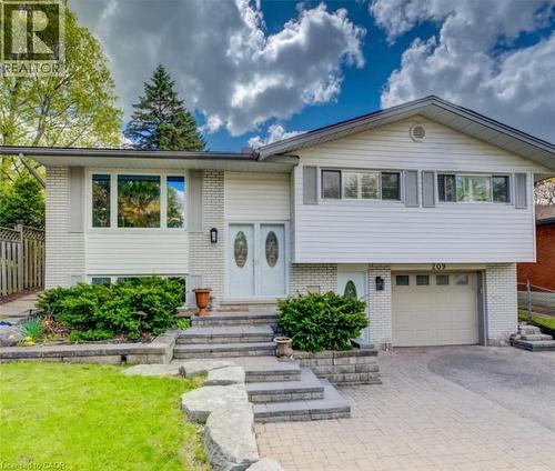 Split-level residence featuring white siding and light-colored brick accents - 209 Willowdale Avenue Unit# Upper, Waterloo, ON - Outdoor