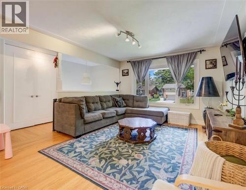 Living room featuring light wood-finish flooring, white walls, and a large window with exterior visibility - 209 Willowdale Avenue Unit# Upper, Waterloo, ON - Indoor Photo Showing Living Room