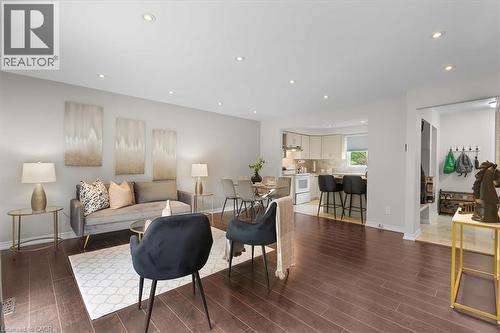 Open-concept living area featuring rich wood-finish flooring, recessed lighting, and light neutral wall colors - 421 Bairstow Crescent, Waterloo, ON - Indoor Photo Showing Living Room