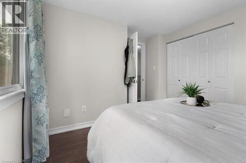 Hardwood-style flooring with white baseboards - 421 Bairstow Crescent, Waterloo, ON - Indoor Photo Showing Bedroom