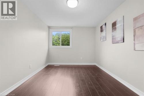 Room with wood-finish flooring, light-toned walls, and white trim - 421 Bairstow Crescent, Waterloo, ON - Indoor Photo Showing Other Room