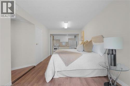 Studio layout featuring wood-finish flooring and a white color palette - 421 Bairstow Crescent, Waterloo, ON - Indoor Photo Showing Bedroom
