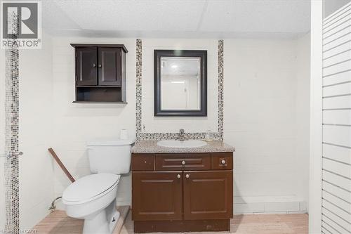 Bathroom featuring a dark wood-finish vanity with a speckled countertop and an undermount sink - 421 Bairstow Crescent, Waterloo, ON - Indoor Photo Showing Bathroom