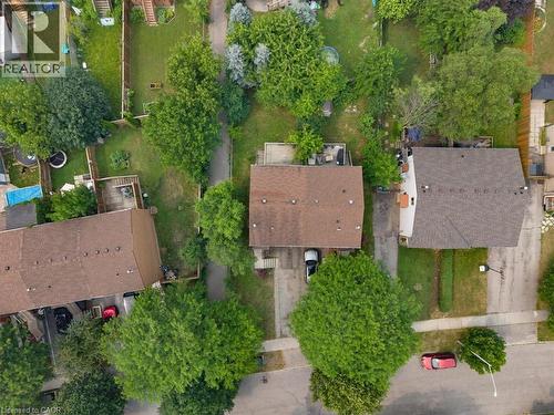 Aerial view of a residential property with a brown shingle roof, a paved driveway, and a partially visible rear deck - 421 Bairstow Crescent, Waterloo, ON - Outdoor