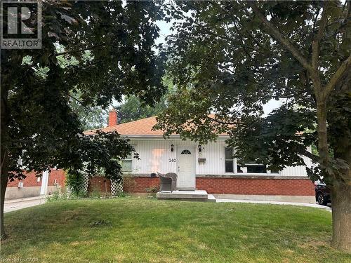 Ranch-style residence featuring a brick foundation and white vertical siding - 240 West 2Nd Street, Hamilton, ON - Outdoor