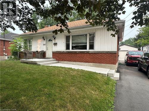 Single-story residence featuring a brick and white vertical siding facade - 240 West 2Nd Street, Hamilton, ON - Outdoor