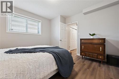 Bedroom featuring wood-finish flooring, a window with blinds, and light gray wall paint - 50 Howe Drive Unit# 9D, Kitchener, ON - Indoor Photo Showing Bedroom